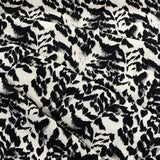 A crepe fabric with a black and white animal style print. Kayes Textiles fabric