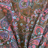 A sheer chiffon fabric with a purple and blue paisley design all over. Kayes Textiles Fabric