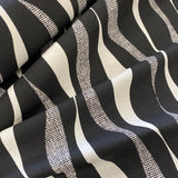 A heavyweight cotton with a geometric wave design in black and cream all across the fabric. Kayes Textiles Fabrics.