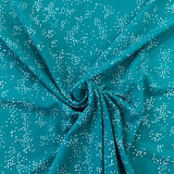 A jade green polyester jersey with white speckle dots all over the fabric. Kayes Textiles fabrics