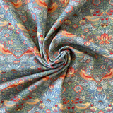 A Grey background cotton with a symmetrical bird and floral design. Kayes Textiles Fabrics.