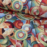 a heavy weight tapestry fabric with geometric circles and swirls in multi colours. Kayes Textiles Fabrics