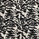 A crepe fabric with a black and white animal style print. Kayes Textiles fabric