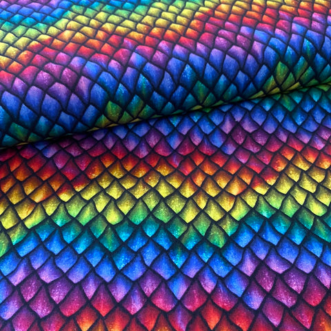 A cotton fabric with a dragon scales design all over in rainbow colours. Kayes Textiles Fabrics. 