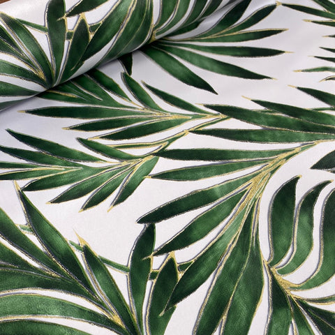 A white plastic fabric with large green  palm leaves all over. Kayes Textiles Fabrics