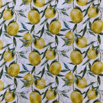 A white cotton fabric with lemons with leaves all over the fabric. Kayes Textiles Fabrics