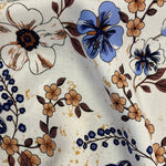 A floaty viscose fabric with a navy floral and paisley design on a cream background Kayes Textiles Fabrics