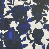 A polyester jersey with a white background and large floral splash pattern in navy and black. Kayes Textiles fabrics