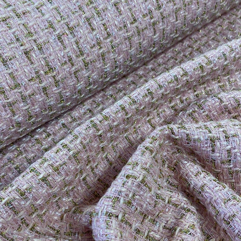 A textured pale pink boucle fabric with a metallic gold weave running through the fabric. Kayes Textiles Fabrics. 