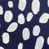 A viscose jersey fabric in navy with large white irregular spots in white on it. Kayes Textiles Fabric