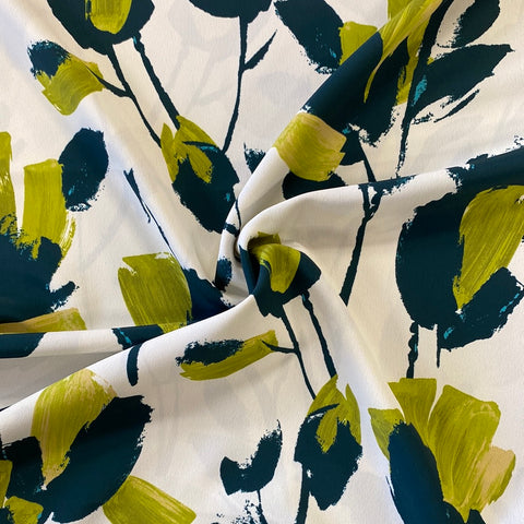 An ivory crepe de chine fabric with large abstract painted flowers in lime and bottle green colour. Kayes Textiles fabrics