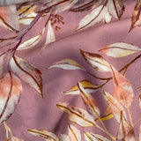 A floaty viscose fabric with grey leaves on a rose coloured  background Kayes Textiles Fabrics