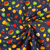 A navy cotton fabric with small fruit salad items all across the fabric icluding watermelons, lemons and apples. Kayes Textiles Fabrics.