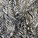 A polyester jersey in a cream colour with black animal print style line design. Kayes Textiles fabrics