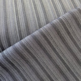 A stretch denim fabric in a charcoal colour with black stripes running throught it. Kayes Textiles Fabrics