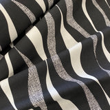 A heavyweight cotton with a geometric wave design in black and cream all across the fabric. Kayes Textiles Fabrics. 