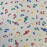 A white fabric with small coloured music notes all over. Kayes Textiles Fabrics