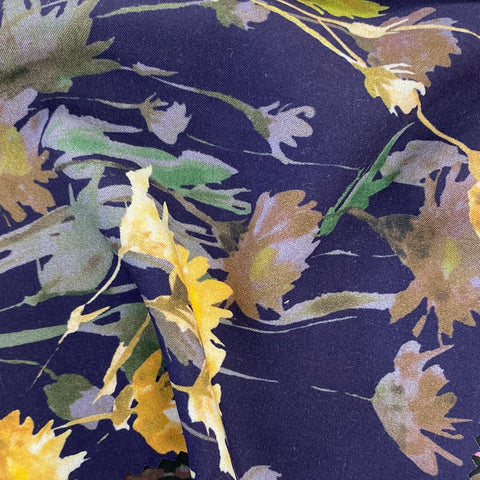 A floaty viscose fabric with bursts of yellow flowers and shadows of flowers on a navy background Kayes Textiles Fabrics