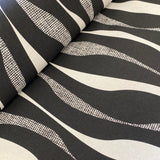 A heavyweight cotton with a geometric wave design in black and cream all across the fabric. Kayes Textiles Fabrics.