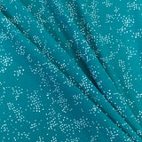 A jade green polyester jersey with white speckle dots all over the fabric. Kayes Textiles fabrics