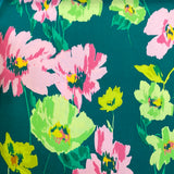 A green polyester jersey with large pink, yellow and green flowers. Kayes Textiles fabrics