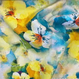 a floaty viscose fabric with a mix of blue and yellow water colour flowers  Kayes Textiles Fabrics