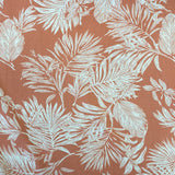 A pink salmon viscose fabric with white brushed lotus leaves all over. Kayes Textiles Fabrics.