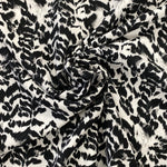 A crepe fabric with a black and white animal style print. Kayes Textiles fabric