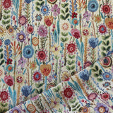 A natural coloured heavy tapestry fabric with coloured flowers all over . Kayes Textiles Fabrics.