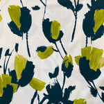 An ivory crepe de chine fabric with large abstract painted flowers in lime and bottle green colour. Kayes Textiles fabrics