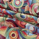 a heavy weight tapestry fabric with geometric circles and swirls in multi colours. Kayes Textiles Fabrics