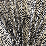 A polyester jersey in a cream colour with black animal print style line design. Kayes Textiles fabrics