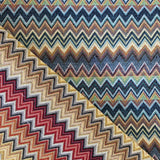 A heavy tapestry fabric with coloured zig zag designs running all across. One side in blues and naturals  the reverse in reds and naturals. Kayes Textiles fabrics