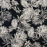 A black viscose fabric with white brushed lotus leaves all over. Kayes Textiles Fabrics. 