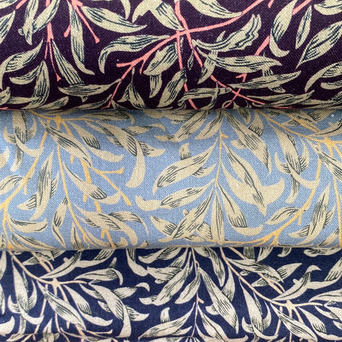 Three fabrics, one grey one navy and one damson all with the same willow pattern all over the fabric. Kayes Textiles Fabrics