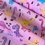 Polycotton Children's Print - Smiling Dinosaurs - Pink - £3.00 Per Metre - Sold by Half Metre