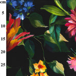 A floaty viscose fabric with bright coloured flowers and leaves on a black background Kayes Textiles Fabrics
