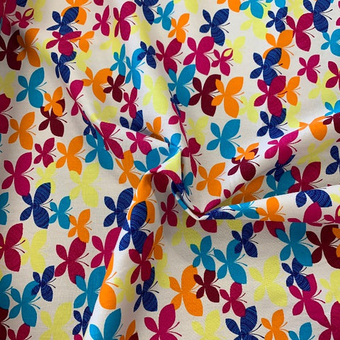 Multicoloured butterflies on white background 100% cotton poplin perfect for summer clothes crafts dresses tops Kayes Textiles dressmaking Southend Westcliff sewing fabric shops cool clothes Metre discount cheap 